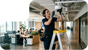 Technician installing a surveillance camera
